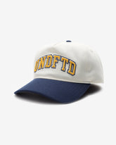 UNDEFEATED 2-TONE ARCH SNAPBACK - IVORY/ NAVY