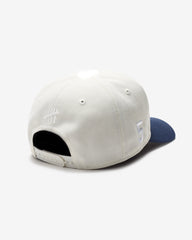 UNDEFEATED 2-TONE ARCH SNAPBACK - IVORY/ NAVY