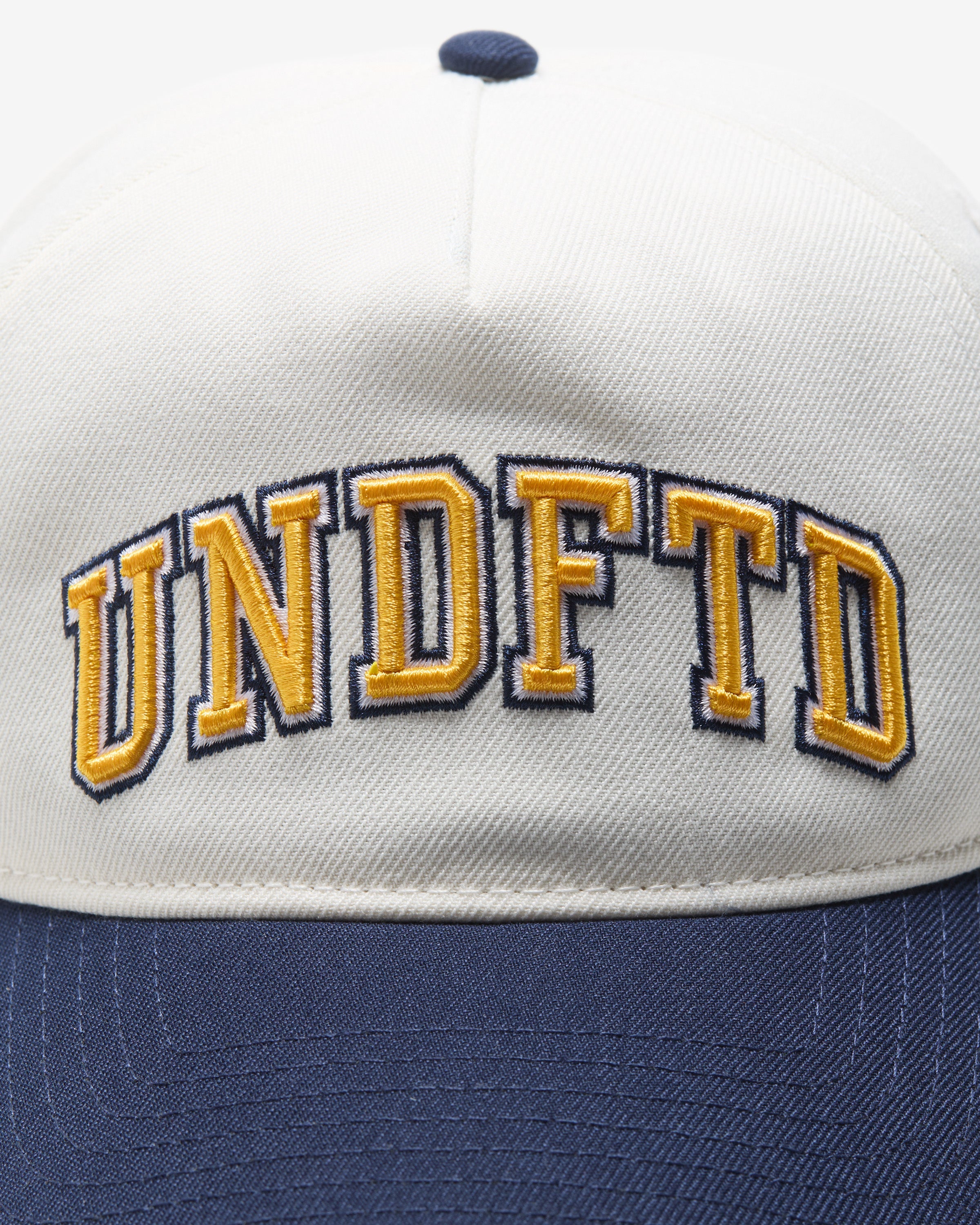UNDEFEATED 2-TONE ARCH SNAPBACK - IVORY/ NAVY
