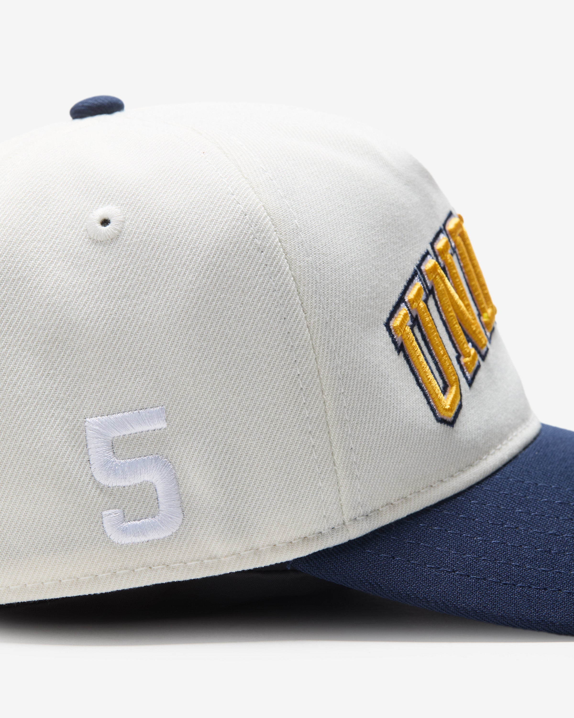 UNDEFEATED 2-TONE ARCH SNAPBACK - IVORY/ NAVY